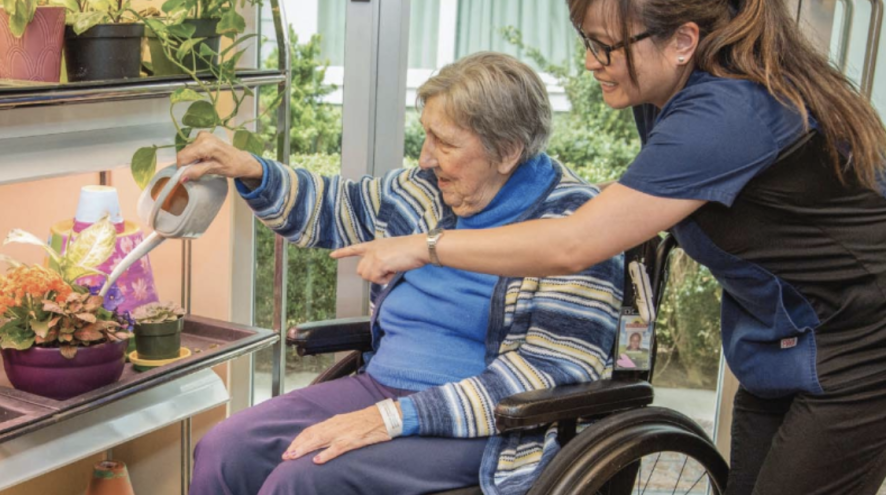 Home care aid helping woman