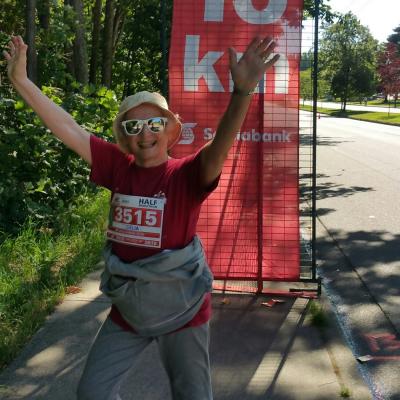 Delia with her arms in the air, celebrating the end of the race.