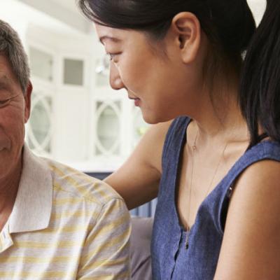 Daughter with her arm around her father,