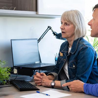 two people looking at the monitor and discussing