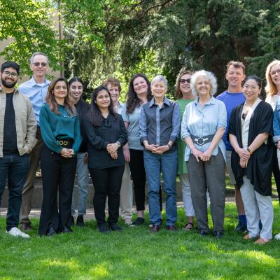 a group of people smiling and standing together outside