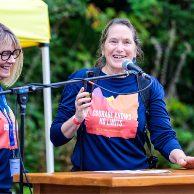 Sue Oakey speaking on stage at the Climb for Alzheimer's 2024