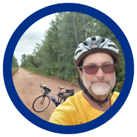Jim Landry taking a selfie in front of his bicycle